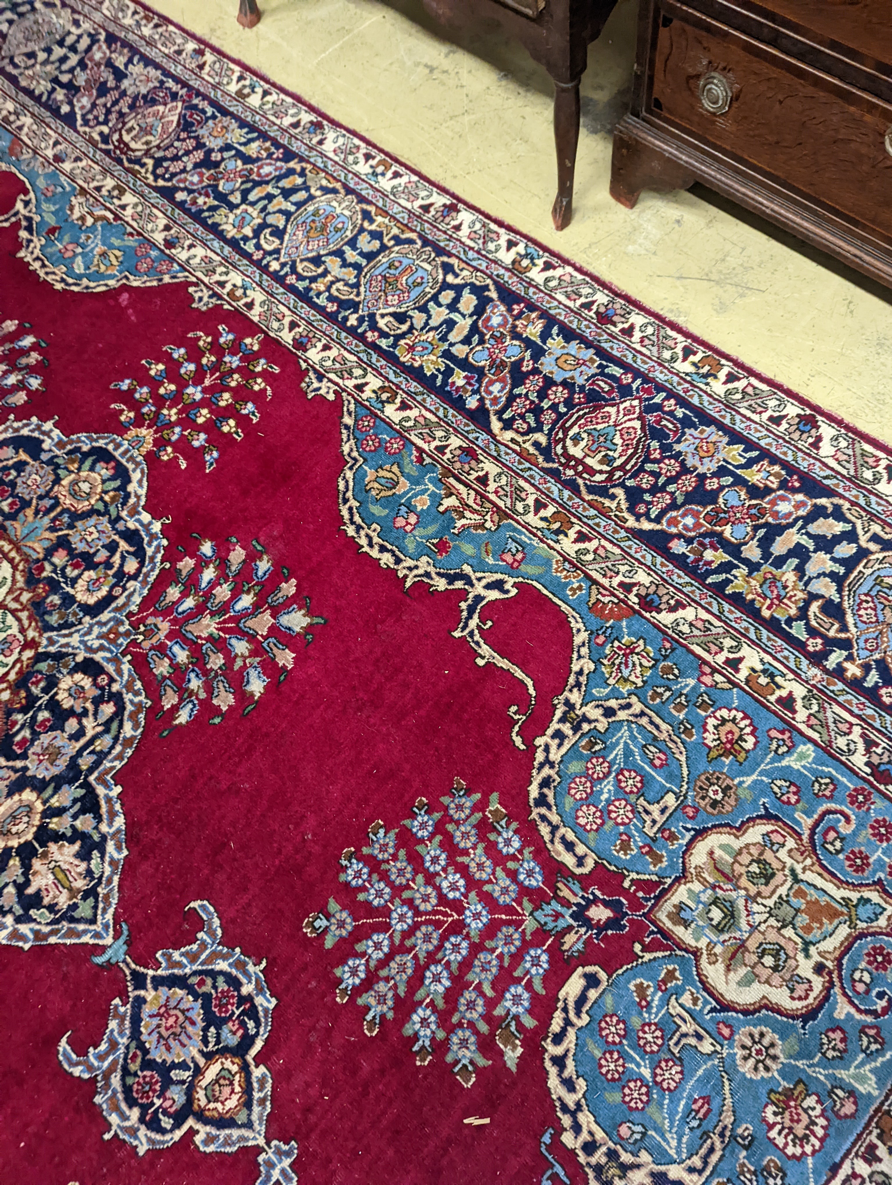 A Tabriz burgundy ground carpet, 350 x 240cm